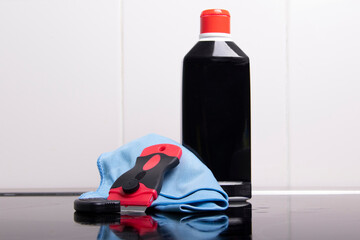 Bottle with cleaning agent on the background of the stove