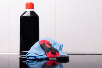 Bottle with cleaning agent on the background of the stove
