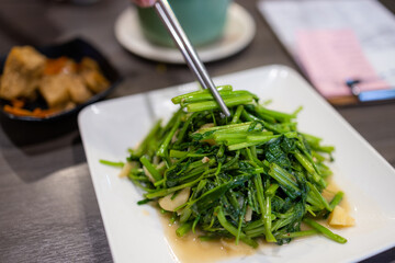 Fry water spinach dish in restaurant