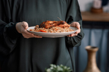 Kabsa close-up, rice and meat dish, saudi arabia national traditional food. Muslim family dinner,...