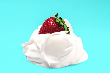 On a blue background, juicy red strawberries with cream. close-up.