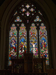 St John the Evangelist Church in Otterburn, Northumberland, UK with stained glass windows.