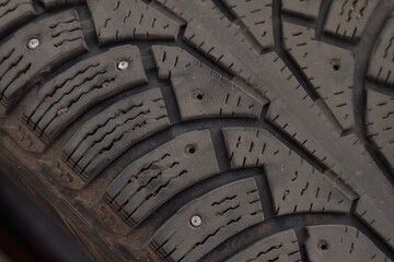 Old winter tires of a car with torn spikes for not sliding on ice
