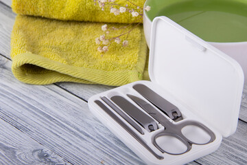 Manicure set on the background of light wood and green towel