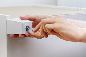 Professional Furniture Assembly Worker Assembles Shelf. Furniture assembly process. Assembling several pieces of furniture. DIY Assembling