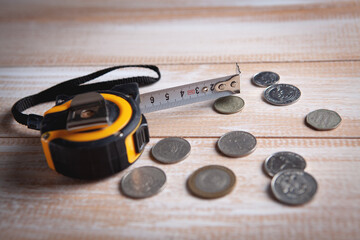 measuring tape and coins on the table