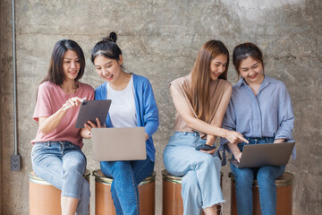 Smart group asian creative business people using electronic devices tablet phone and laptop in office. Creative lifestyle young people concept