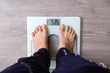 Young Woman Standing On Weighing, Top View