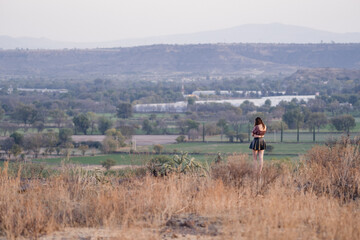 Fototapeta na wymiar Wide landscape with a pretty woman in a skirt