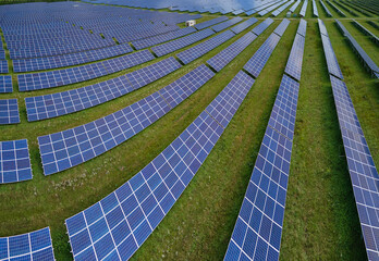 Aerial view of big sustainable electric power plant with many rows of solar photovoltaic panels for producing clean electrical energy. Renewable electricity with zero emission concept