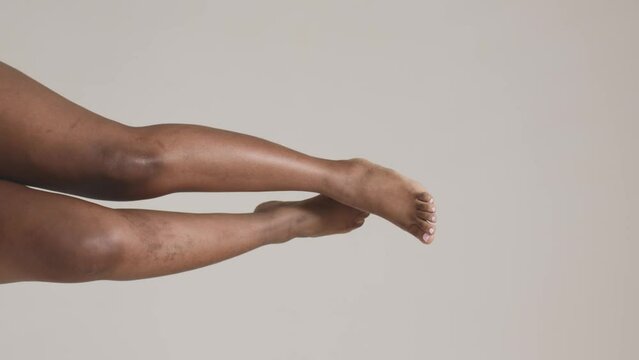 African american woman raised up her unperfect legs. Body neutrality concept. ProRes codec. Vertical cropped video