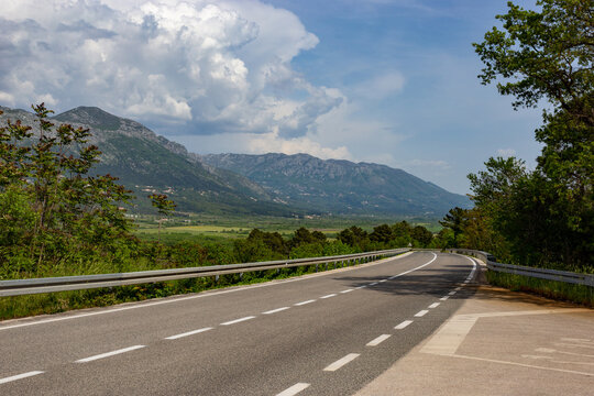 Road in valley. Mountain landscape with dramatic sky. A storm is coming from the mountains.