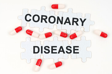 On a white surface, tablets and puzzles with the inscription - Coronary disease