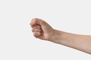 Female hand with manicure in fist on white.