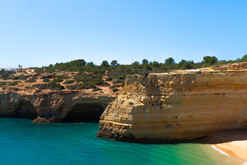Natural caves on the beach of Marinha, Algarve Portugal. Rocky arches on Marinha beach and turquoise waters off the coast of Portugal in the Algarve region.