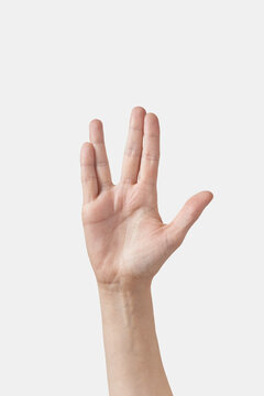 Funny alien hello gesture female hand on white.