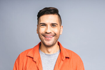 Happy young man. Portrait of handsome young ukrainian man in casual smiling while standing isolated over white grey background.