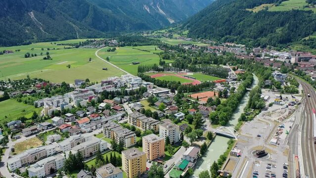 Beautiful mountain view in the city of Lienz, Austria. Alpine mountains, clouds and sunlight over the city. Aerial view over the Austrian city in the mountains Alps	
