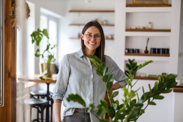 Portrait of a young woman standing in her home
