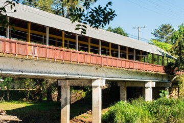 Paranhana river and a view of the covered bridge - a historical landmark in Tres Coroas, Brazil