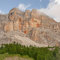 East face of Sasso di Santa Croce mountain range in the eastern Dolomites, its 900 meters vertical wall and Mount Cavallo, seen from Roda de Armentara trail to St. Croce refuge, South Tyrol, Italy