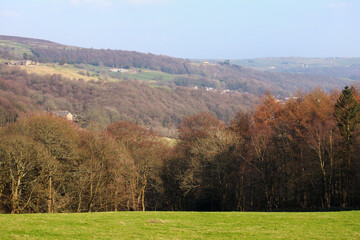 view of the calder valley above hebden bridge looking towards mytholmroyd with autumn woodland and pennine hills