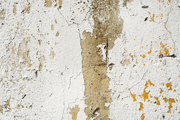 Old abstract wall background. Concrete painted surface with cracks and yellow peeling paint. Grunge background texture 