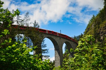 Railway bridge in Switzerland. Landwasser Viaduct in Graubunden near Davos Klosters Filisur. Railway company emblem.