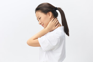 Neck ache. Tormented from fibromyalgia tanned beautiful young Asian woman rubbing massaging tensed muscles posing isolated on white background. Injuries Poor health Illness concept. Cool offer Banner