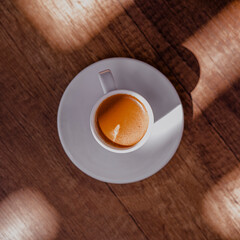Turkish coffee with a lot of foam in a small white cup