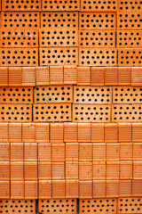 Large old wall, background, texture of dirty brown, red, orange reflened bricks cracked in spots with holes. Photo of building materials.