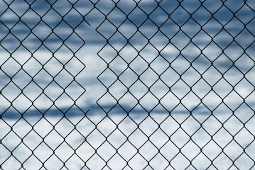 gray background, in the photo a metal mesh on a background of white snow