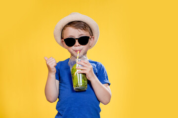 Summer refreshment. Cold beverage. Little boy with plastic cup of fresh lemonade