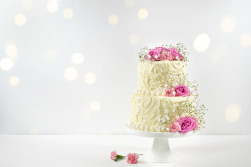 Wedding, Birthday 2 Tiered Cake for Cake Topper Mockup. Styled with fresh pink roses and gypsophila...
