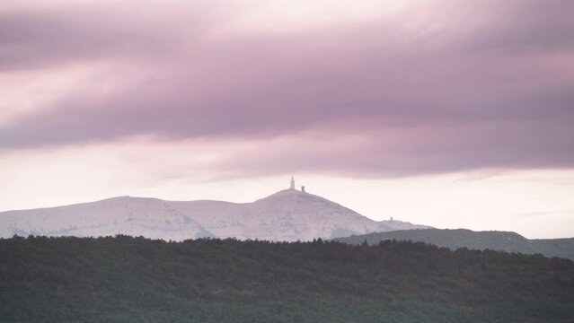 Time lapse. Clouds moving in the evening over mountain landscape with Mont Ventoux in the distance, view from Baronnies Provencales Natural Park in France.