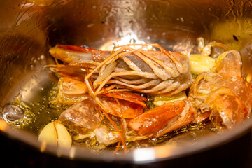 Tasty appetizing roasted shrimps prawns with spices on pan with ingredients on black background. Top View with Copy space. Food Background Italian Kitchen Concept.