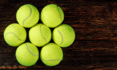 Tennis balls on wooden background, space for text, sport and competition concept