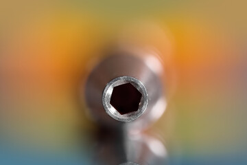 Close up view of Screw driver bit holder against colorful background.