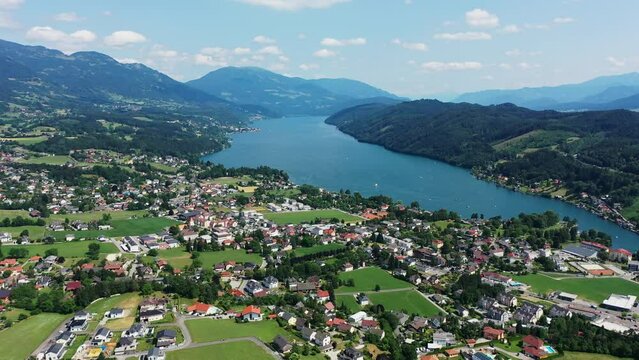 Drone view over Millstatter see in Austria, in the Dolomites. Aerial video of the lake and houses near it, the calm atmosphere of the Austrian Karntern