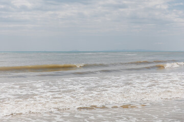 Seascape. Foam waves at sandy beach. Waterscape for background. Nature concept. Soft focus. Motion waves. Copy space.