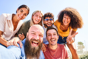 Cheerful Group of guys and girls posing for a selfie photo and having fun. Friendship and community concept
