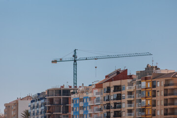 Fototapeta na wymiar Construction crane on the background of houses