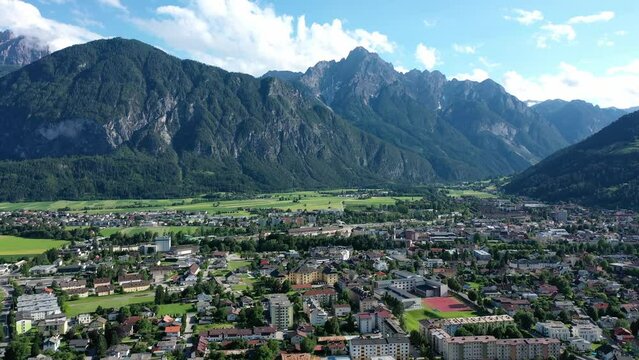 Beautiful mountain view in the city of Lienz, Austria. Alpine mountains, clouds and sunlight over the city. Aerial view over the Austrian city in the mountains Alps	

