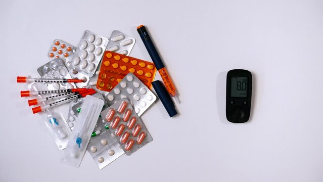 Glucometer with blood glucose meter is placed on table with medicine. Electronic device for measuring sugar.Syringe pen with insulin, hormone that is not produced by pancreas in patients with diabetes