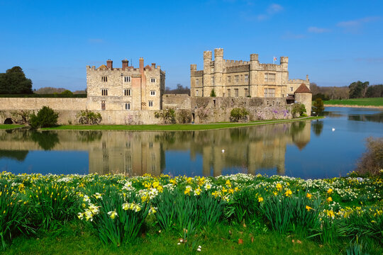View of Leeds Castle in Kent, UK. Leeds Castle, England, reflection, spring sunny day, with flowers blooming.