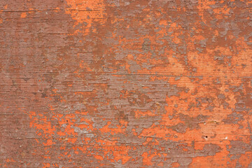 Old wooden and painted surface with exfoliated paint. Several layers of paint with cracks.