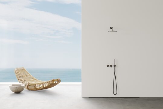 Aesthetic modern minimalist bathroom open shower  with wooden sunbedand. Ocean view from the panoramic windows. Balinese style