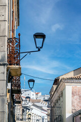 Row of streetlights on narrow street