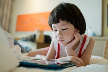 kid watching tablet, child addicted cartoon
