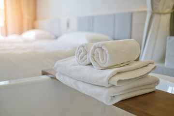 Fototapeta na wymiar cleaning hotel, bath towel on white bed, room service 